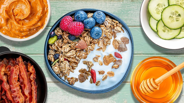 Greek yogurt bowl with berries and granola surrounded by various ingredients