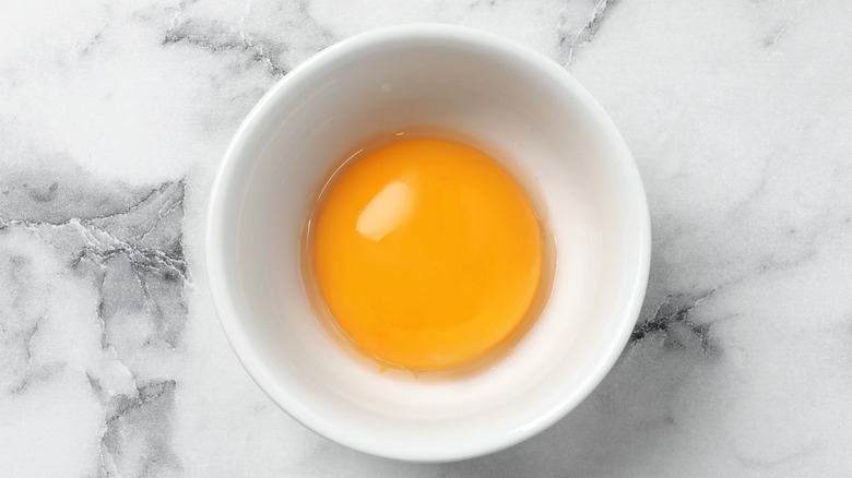 Raw egg yolk  in ramekin