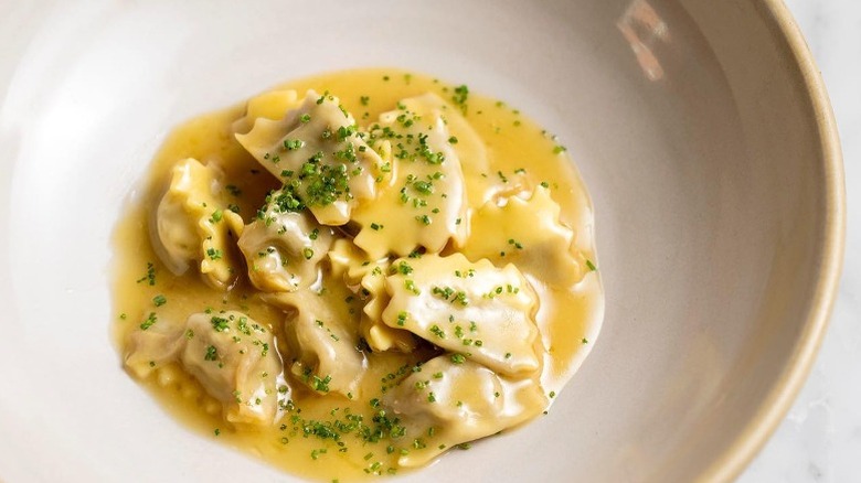 agnolotti with chives in bowl