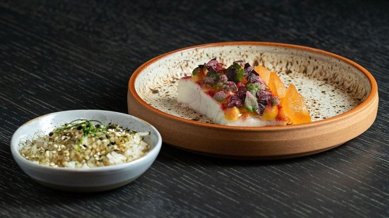 A plate of snapper and bowl of rice