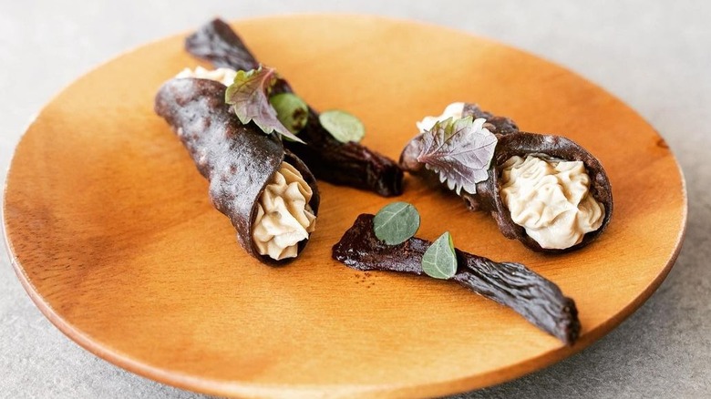 Chocolate Cannoli on a wooden plate