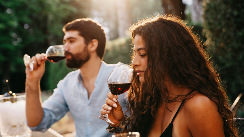 couple sniffing and drinking wine