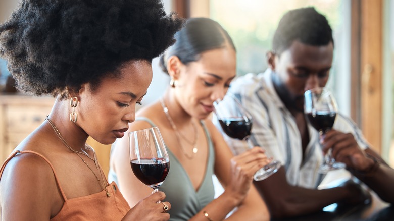 friends smelling wine glasses