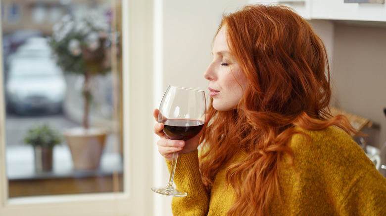 woman enjoying glass of wine