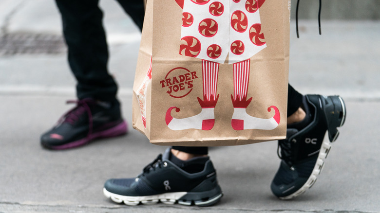 Shopper carrying Trader Joe's bag