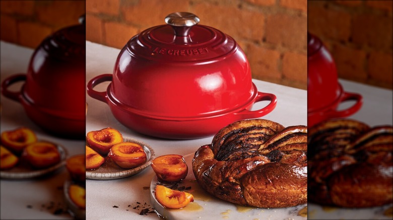 Le Creuset enameled cast iron bread oven on table with bread