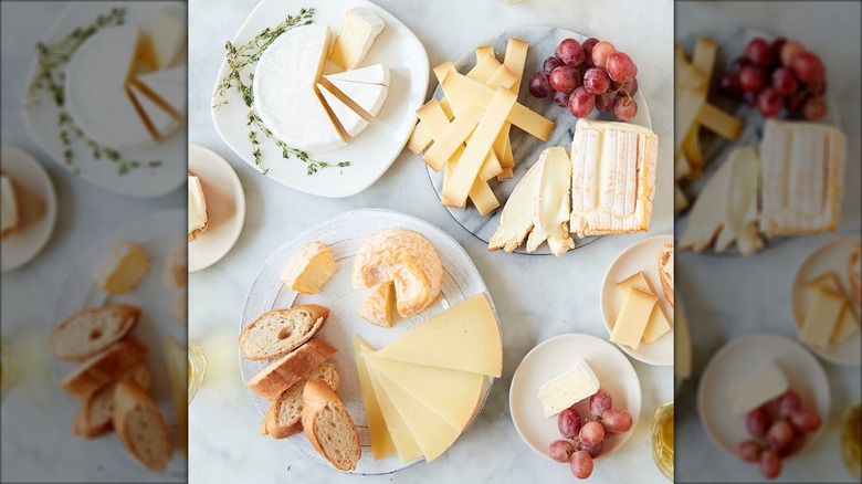 platters of cheese, grapes, and bread on marble counter