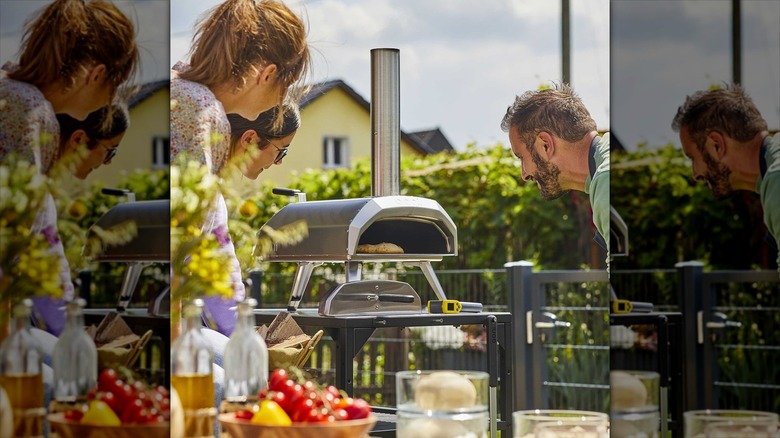 Ooni Karu12 Multi-Fuel Outdoor Pizza Oven surrounded by people