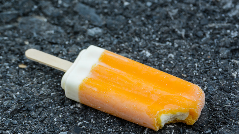 Orange creamsicle on ground