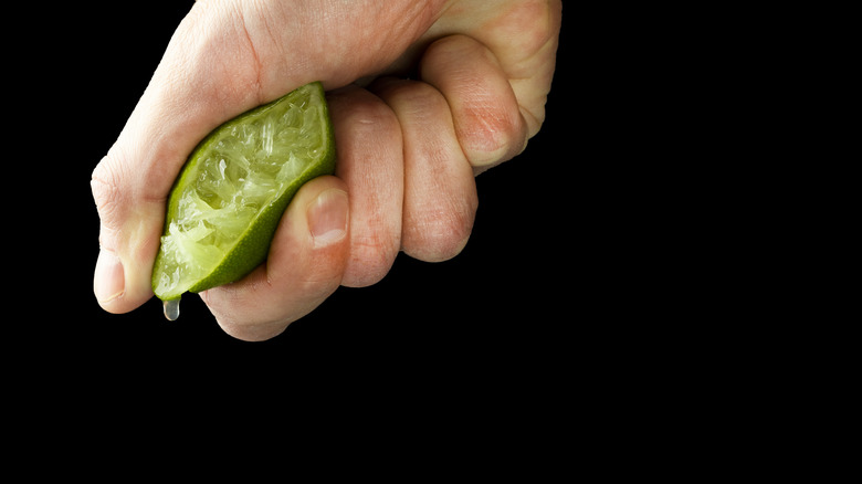 Person squeezing lime