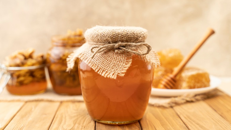 Jar of honey on wood