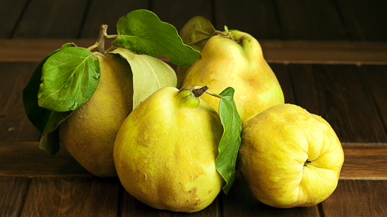 Quinces on wood background