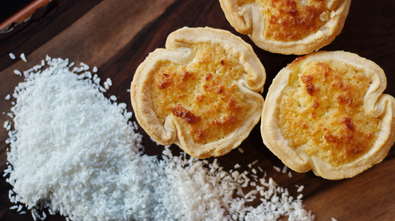 Coconut tarts on wooden background