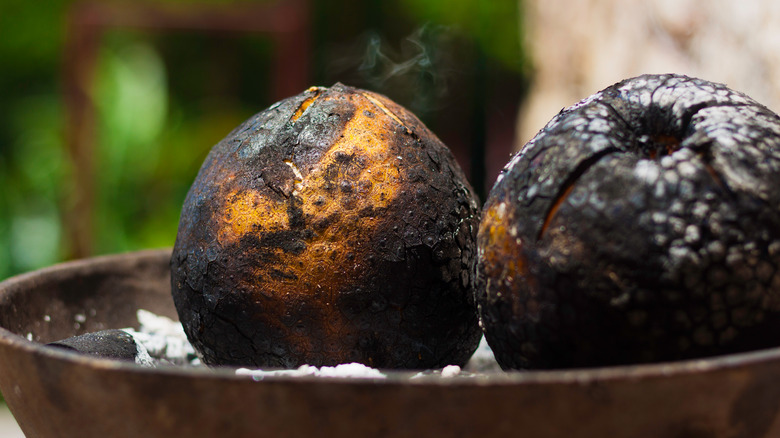 Roasted breadfruit on open fire