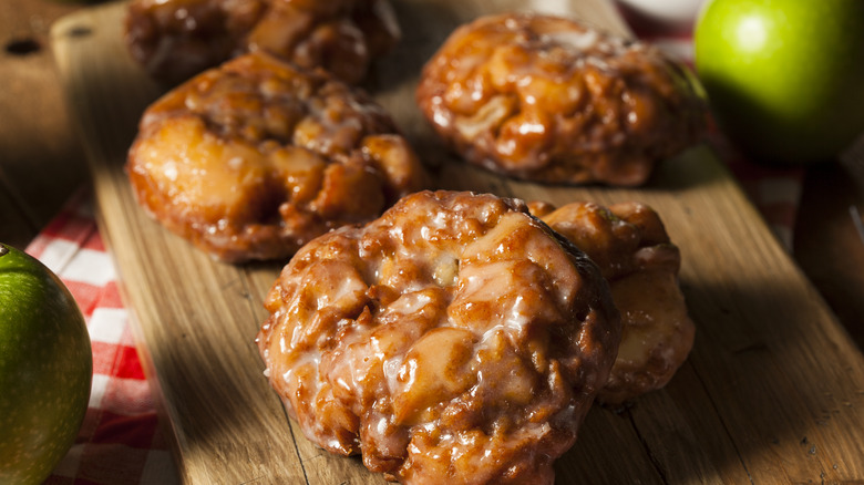 Glazed apple fritters on plate