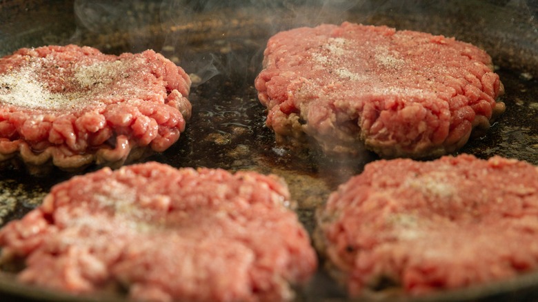 Dimpled burgers on griddle