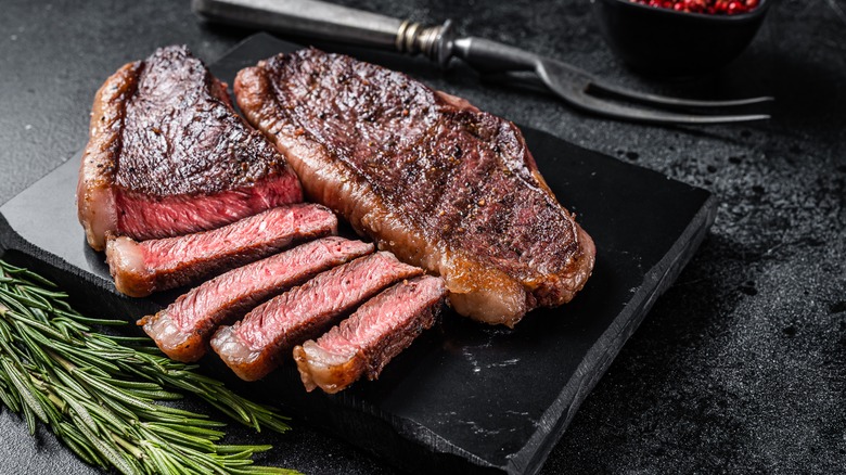 Sliced steak on cutting board