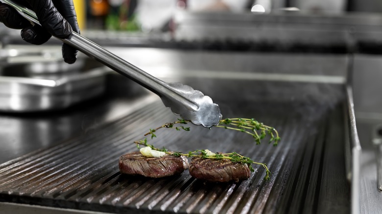 Searing steaks on grill