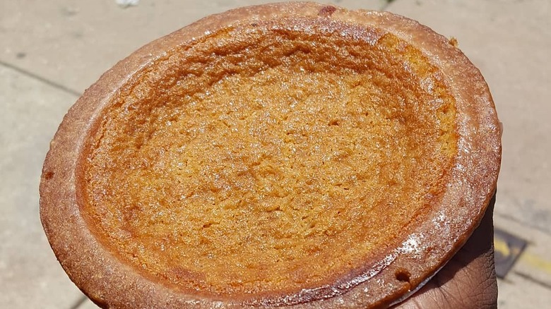 A man holding bean pie