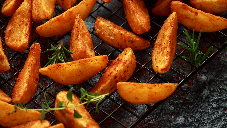 Seasoned potato wedges on grate