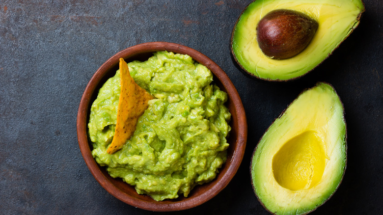 Guacamole bowl and avocado halves