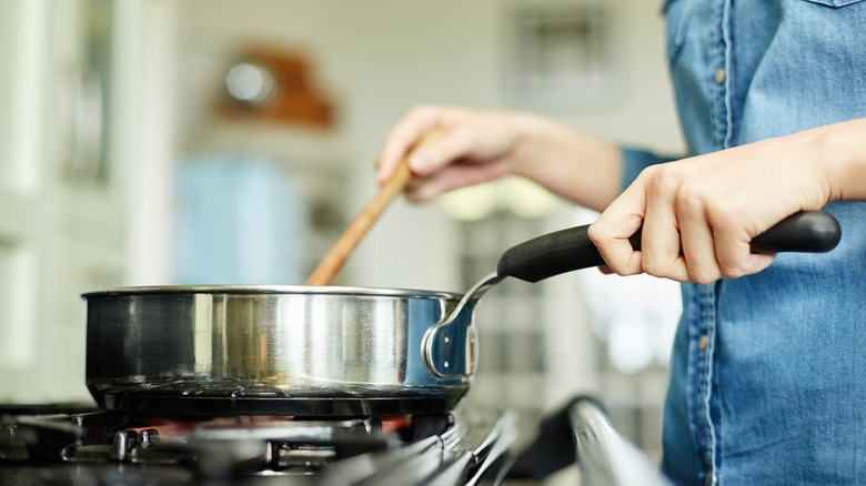 Person cooking on stovetop