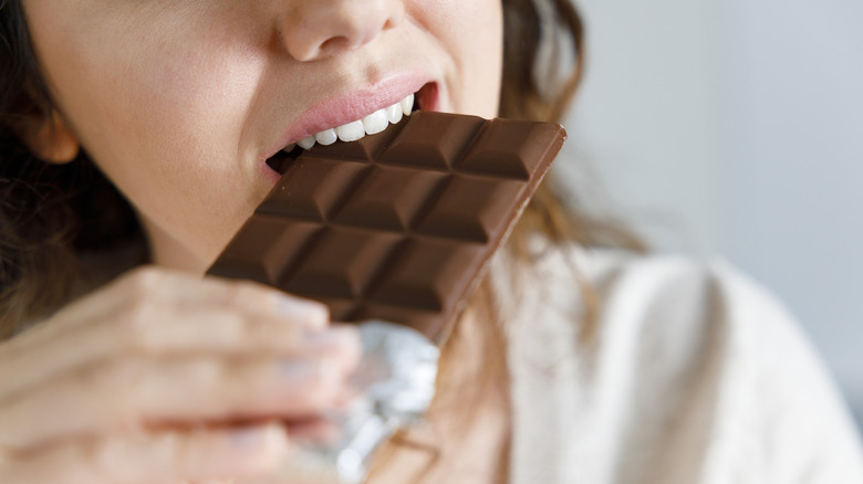 Woman eating chocolate bar