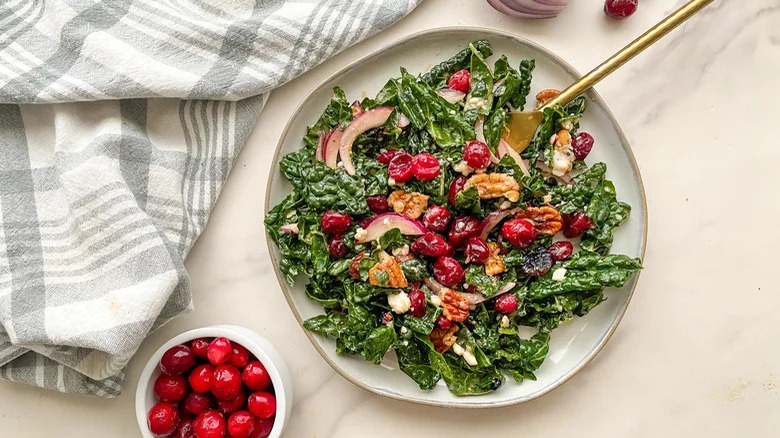 Platter of salad with bowl of cranberries