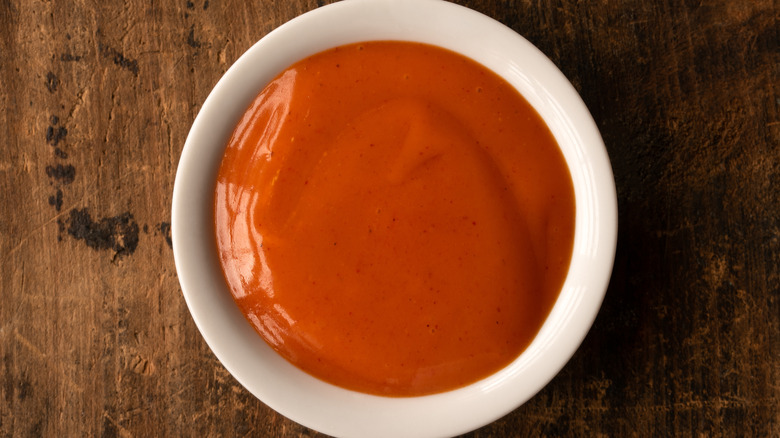 Buffalo sauce in white bowl