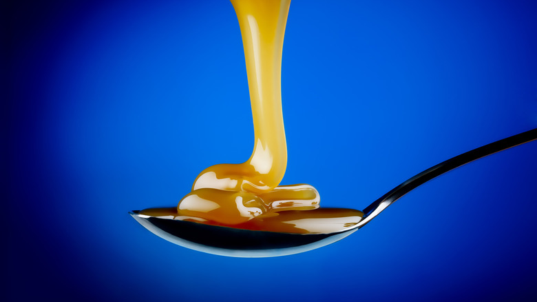 Drizzle of caramel sauce on spoon