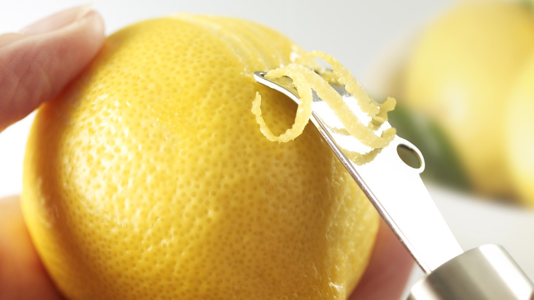 Person zesting a lemon