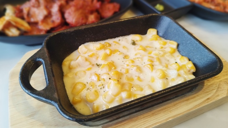 Cast iron skillet of cheesy corn 