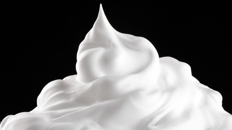 Whipped cream on black background 