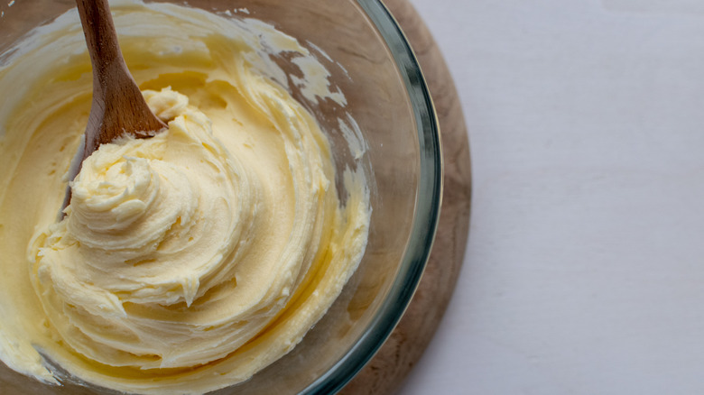 Vanilla frosting in bowl with spoon