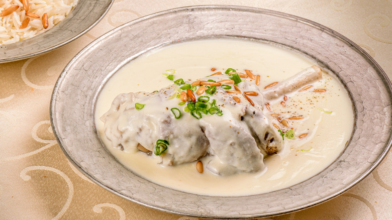 Meat in yogurt sauce on gray plate 