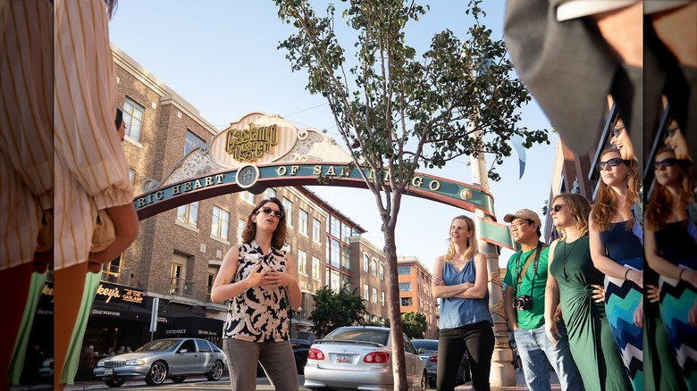 Tour group standing in front of San Diego Gaslamp Quarter sign