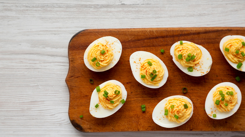 Deviled eggs on wooden board