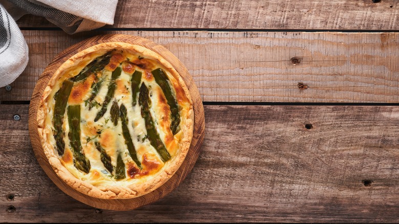 Asparagus quiche on wooden table