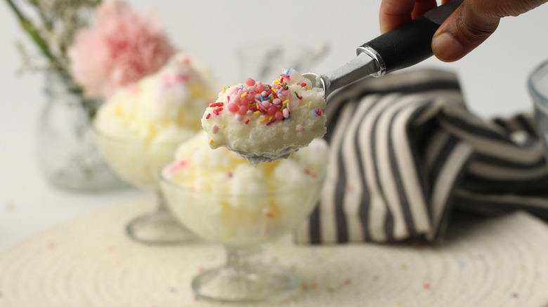 scooping snow cream with sprinkles