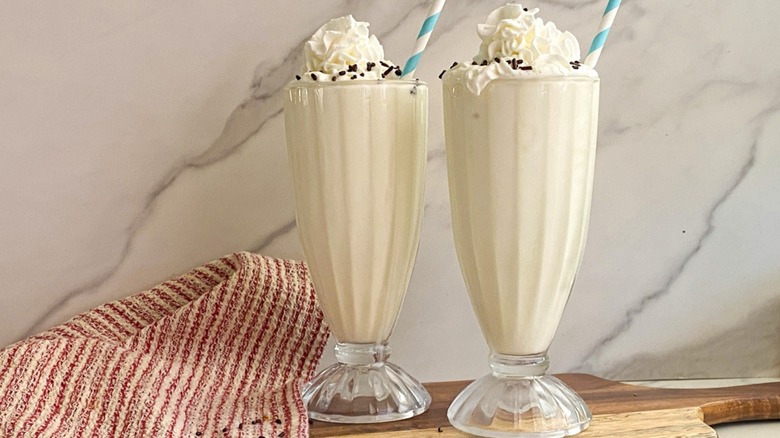 two vanilla milkshakes with cream