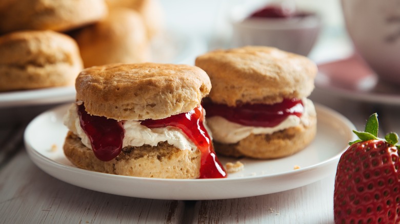 Scones with jam on table