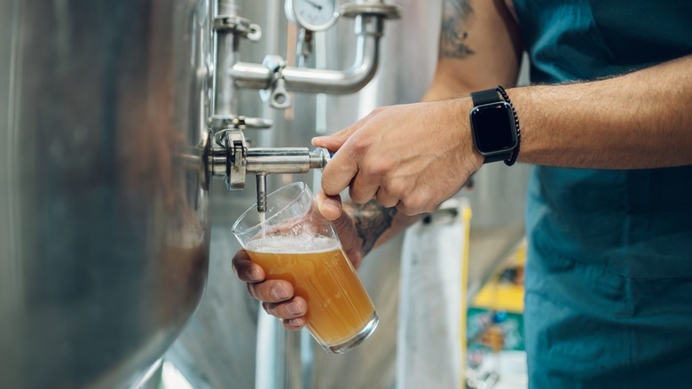 beer being poured from tank