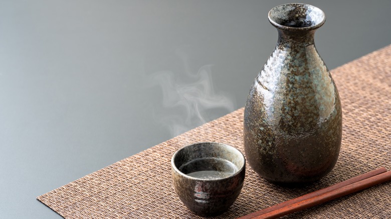 warm sake in cup and bottle 