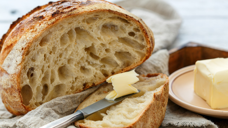 cut sourdough loaf with butter 