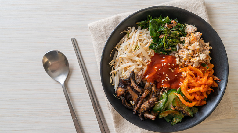 Bibimbap in black bowl