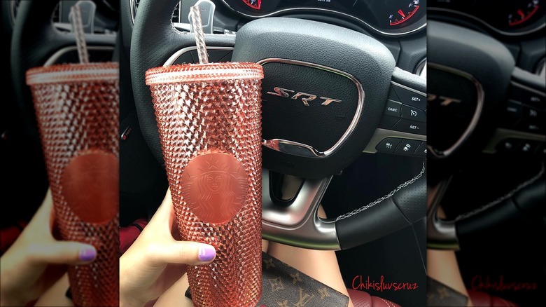 handheld Starbucks rose gold tumbler