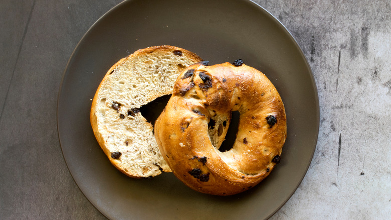 Cinnamon raisin bagel on black plate