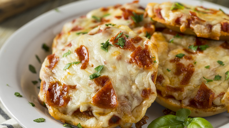 Pizza mini bagels on white plate