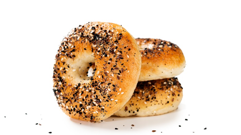 Everything sourdough bagels on white background