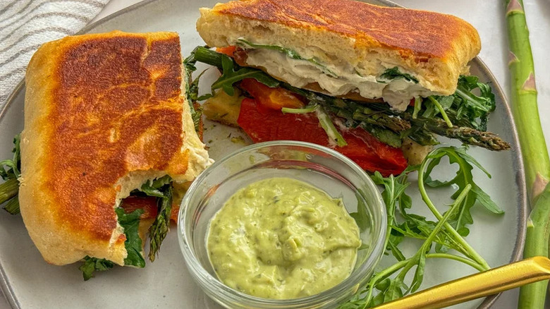 Asparagus and Goat Cheese Panini on white plate with green sauce